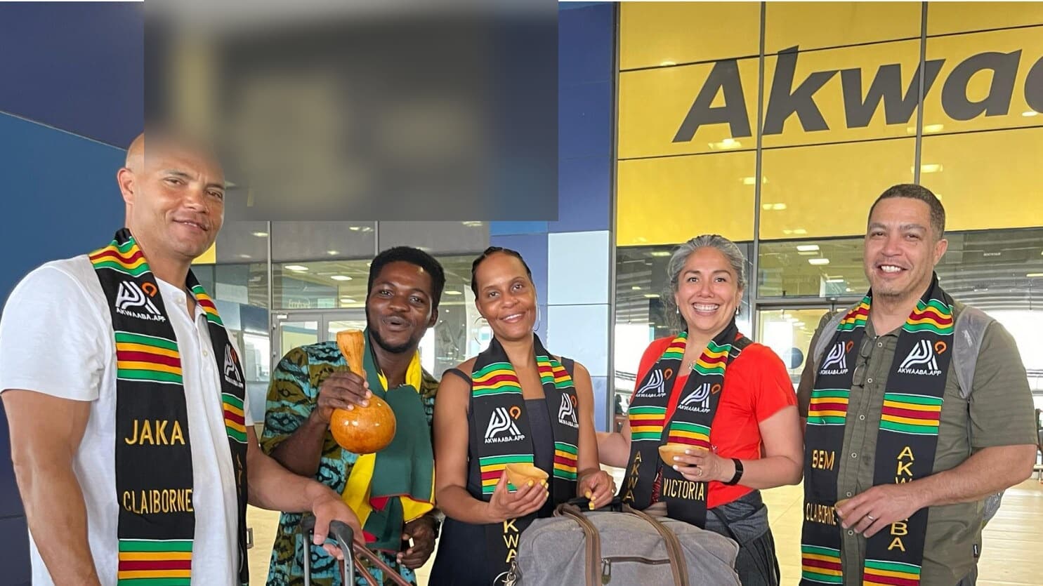 A diaspora family arriving at Kotoka airport in Ghana, welcomed with personalised Akwaaba kente stoles