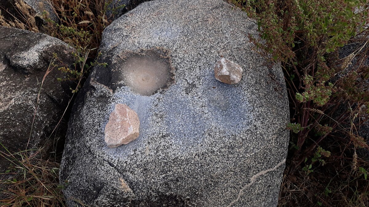 Punishment stone with carved bowl at Pikworo Slave Camp near Paga, Upper East Ghana — site where enslaved Africans were held before transport to coastal castles