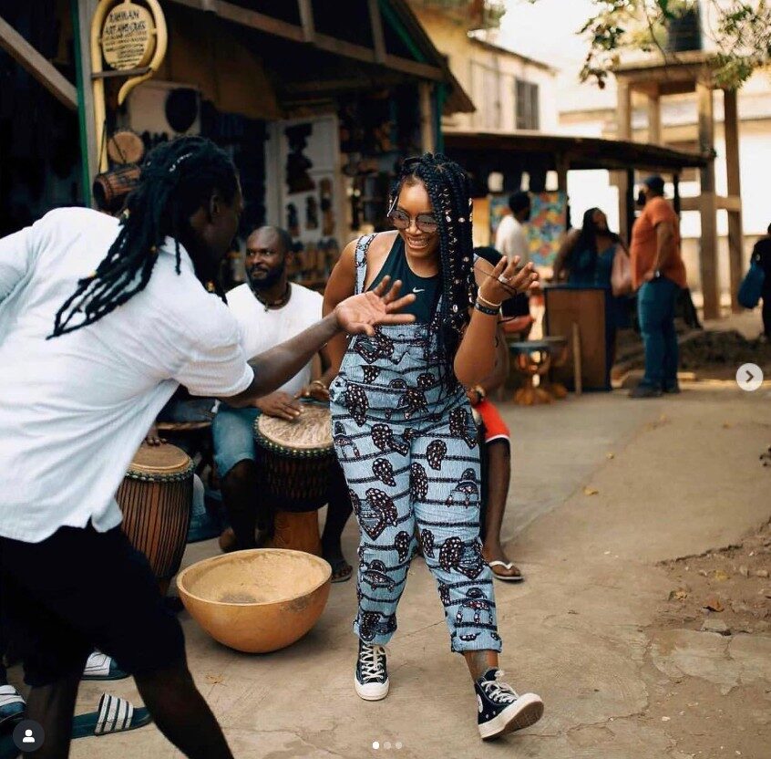 A drummer and guest dancing during an African drumming and dancing session in Accra