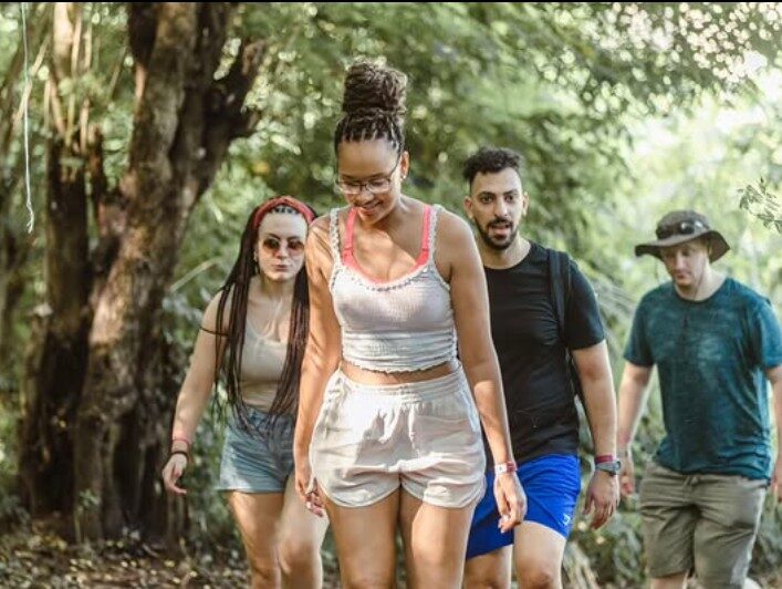 A group hiking a forest trail near Akosombo, Ghana
