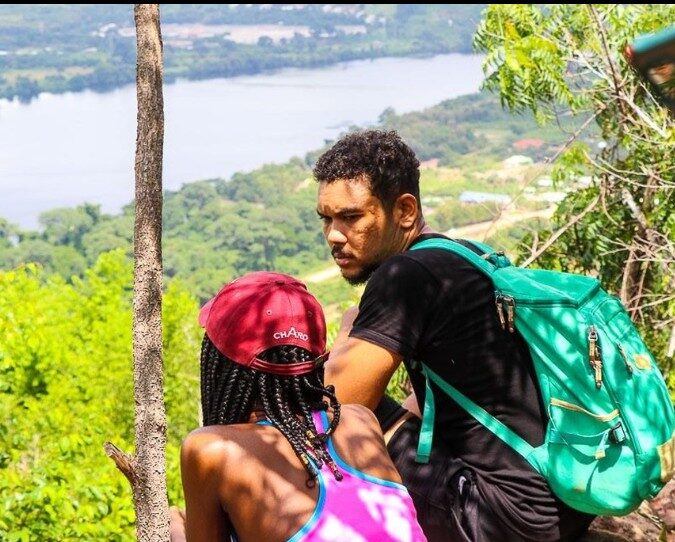 Hikers on a hilltop overlooking the Volta Lake near Akosombo, Ghana