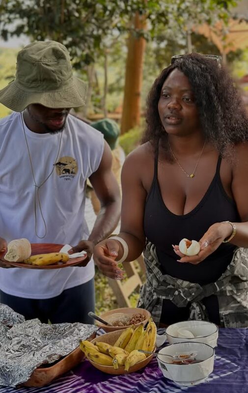 A couple enjoying farm-fresh roasted plantain at Adoko Farms near Accra