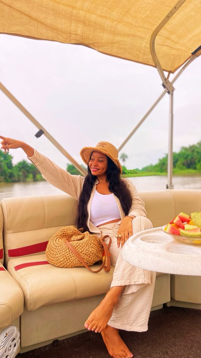 A guest relaxing on a pontoon boat on a Volta Lake cruise in Ghana